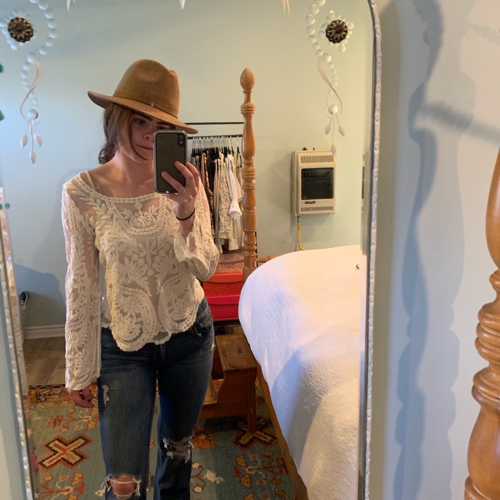 Cream colored lacy long sleeve top.